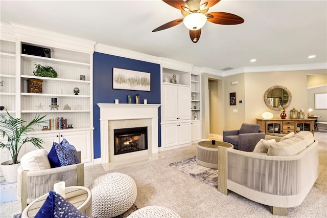 living room featuring built in shelves, recessed lighting, ornamental molding, a fireplace with flush hearth, and ceiling fan