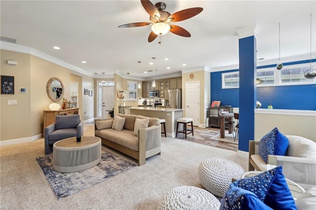 living room featuring light carpet, ornamental molding, visible vents, and baseboards