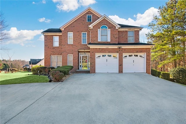 view of front of home with a garage, a front yard, brick siding, and driveway