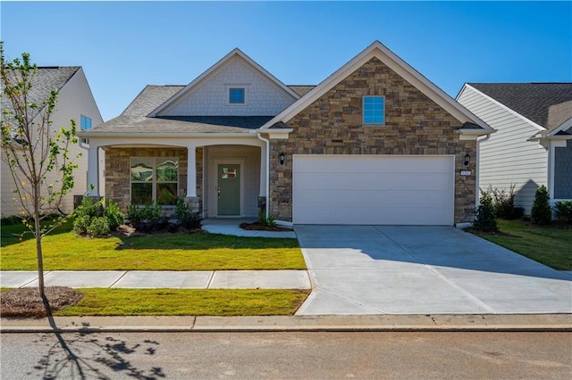 craftsman inspired home with a garage and a front yard