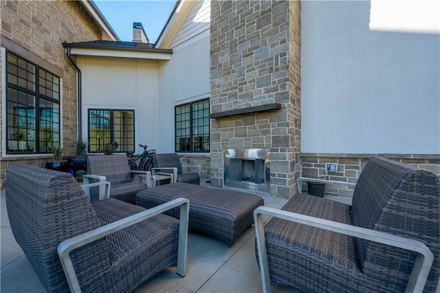 view of patio / terrace featuring an outdoor stone fireplace