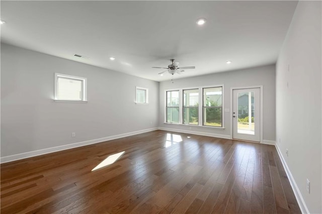 unfurnished room featuring ceiling fan and dark hardwood / wood-style flooring