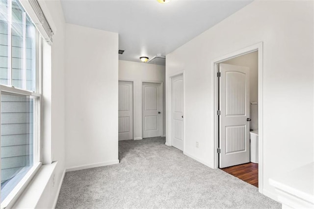unfurnished bedroom with baseboards and carpet flooring