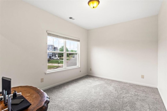 carpeted empty room featuring visible vents and baseboards