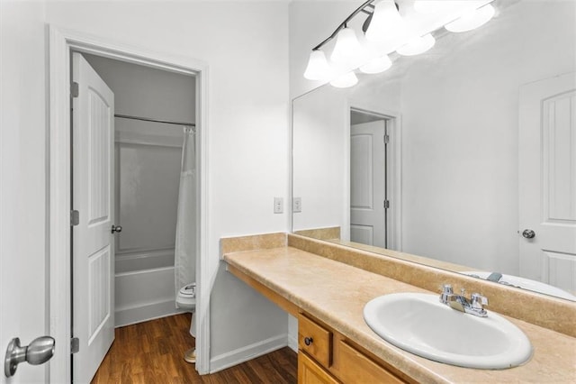 full bathroom featuring shower / bath combo, wood finished floors, vanity, baseboards, and toilet