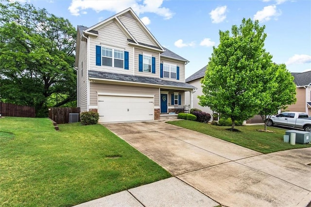 craftsman-style house featuring a garage, fence, driveway, and a front yard