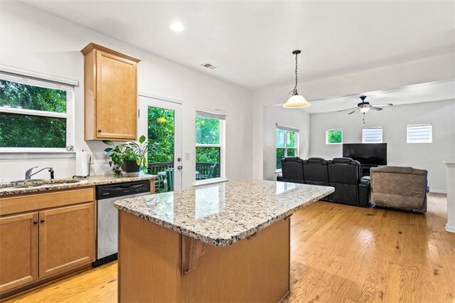 kitchen featuring a ceiling fan, visible vents, stainless steel dishwasher, light wood-type flooring, and a sink