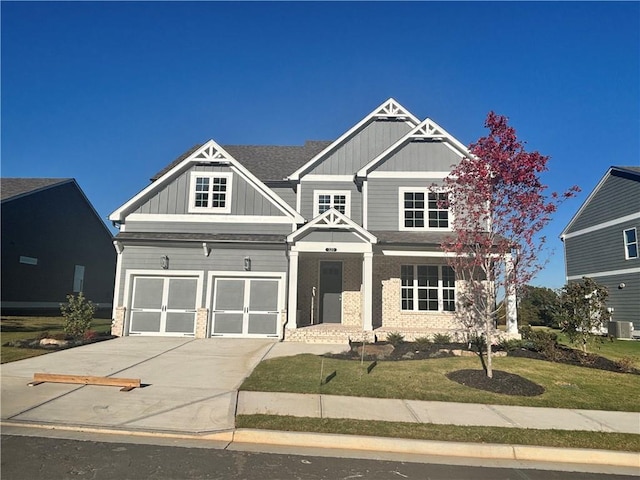 320 Willow Cv, Canton, GA 30114 - craftsman-style house with board and batten siding, a garage, a front lawn, brick siding, and concrete driveway
