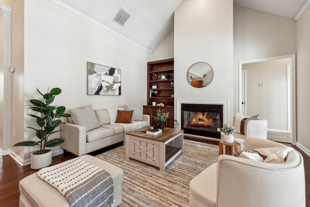 living room featuring wood-type flooring, high vaulted ceiling, and ornamental molding