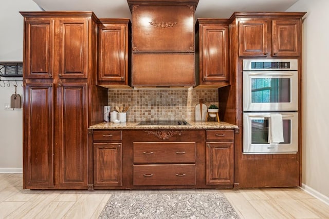 kitchen featuring double oven, black electric cooktop, decorative backsplash, and light stone countertops