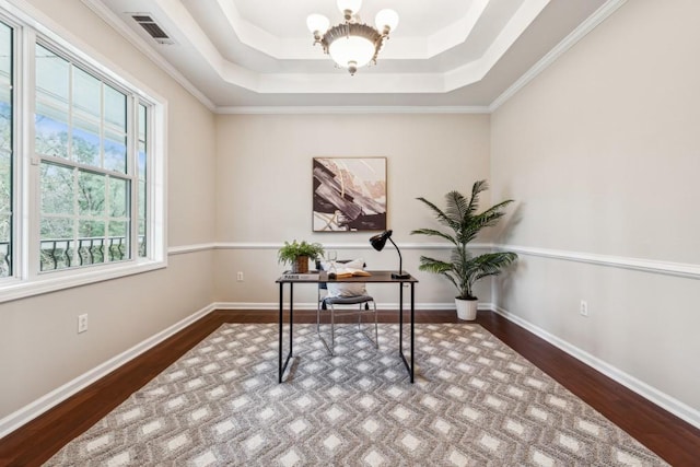 office space with hardwood / wood-style flooring, a tray ceiling, and ornamental molding