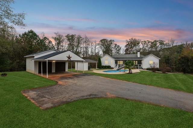 ranch-style house with a yard and a garage