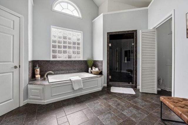 bathroom with high vaulted ceiling and independent shower and bath