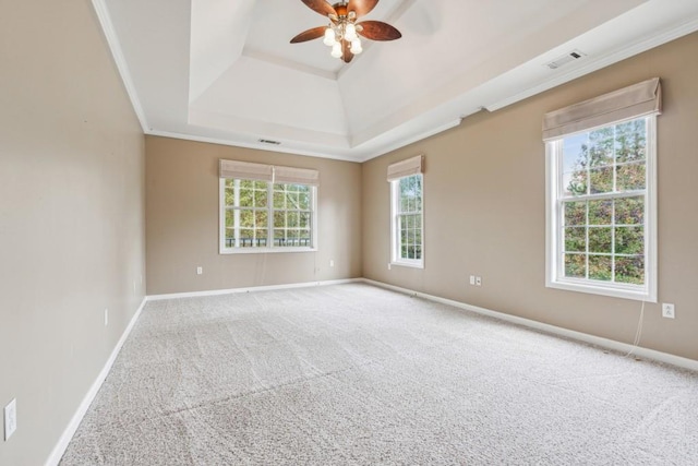 carpeted empty room featuring a tray ceiling, ceiling fan, and ornamental molding