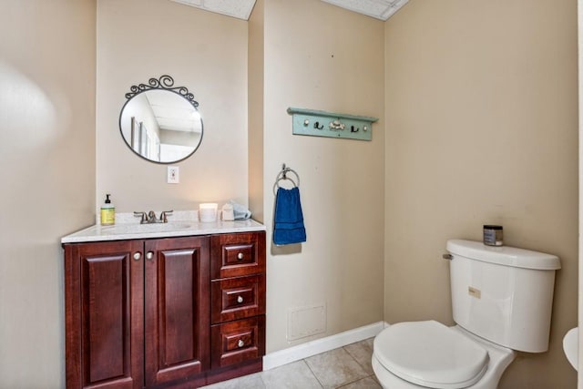 bathroom featuring tile patterned flooring, vanity, and toilet