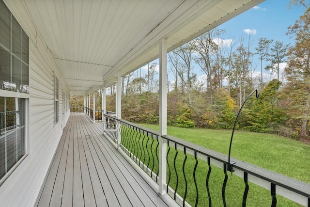 deck with a porch and a yard