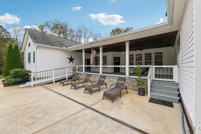 view of patio with ceiling fan and a porch