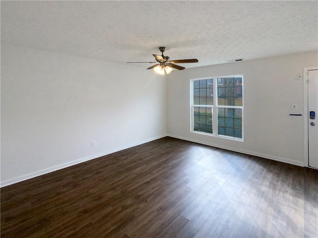 spare room with ceiling fan, dark hardwood / wood-style floors, and a textured ceiling