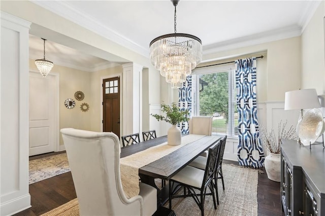 dining room with a notable chandelier, ornamental molding, and dark hardwood / wood-style floors