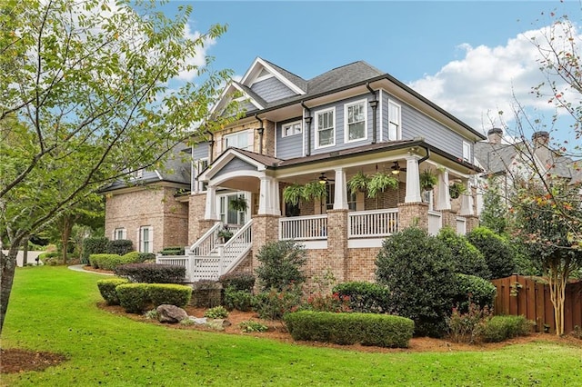 craftsman inspired home with a front yard and a porch