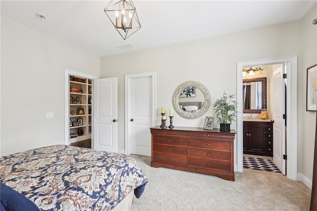 carpeted bedroom with ensuite bathroom