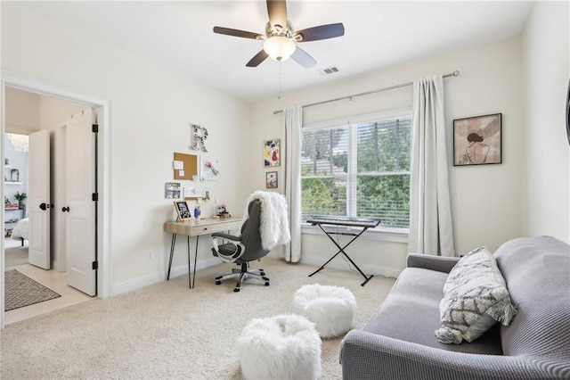 carpeted home office with ceiling fan