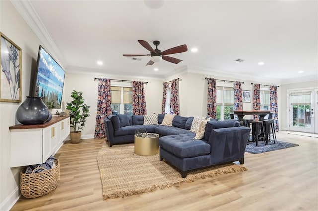 living room with ceiling fan, crown molding, light hardwood / wood-style floors, and plenty of natural light