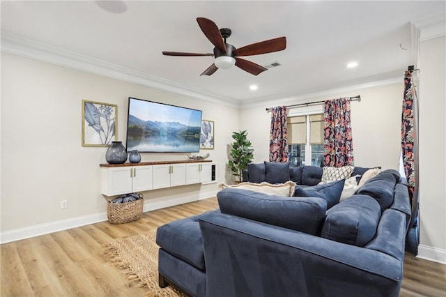 living room featuring ceiling fan, light wood-type flooring, and ornamental molding