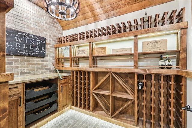 wine room with brick wall and lofted ceiling