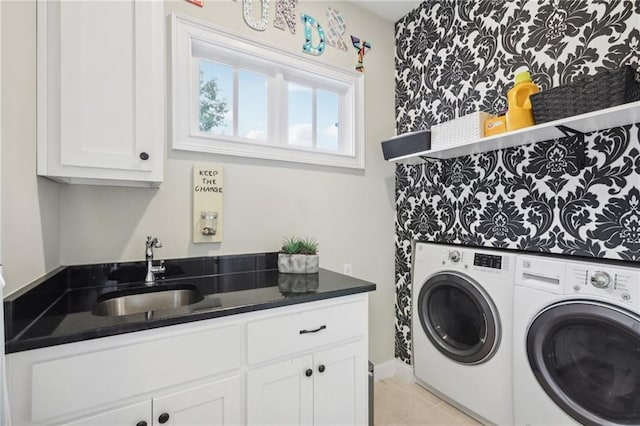 laundry room featuring cabinets, sink, light tile patterned floors, and washing machine and clothes dryer