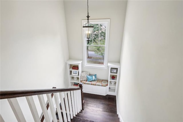 stairway featuring a notable chandelier and hardwood / wood-style floors