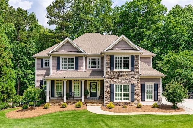 255 Ashmere Ct, Tyrone, GA 30290 - view of front of house with stone siding, a porch, a front yard, and a shingled roof