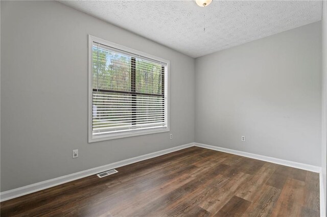700 Bayliss Dr, Marietta, GA 30068 - bedroom featuring baseboards, a textured ceiling, ceiling fan, a closet, and wood finished floors