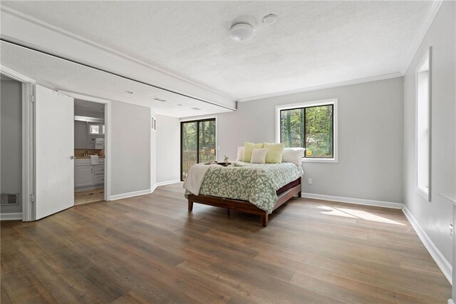 700 Bayliss Dr, Marietta, GA 30068 - unfurnished bedroom featuring baseboards, a textured ceiling, a closet, and dark wood finished floors