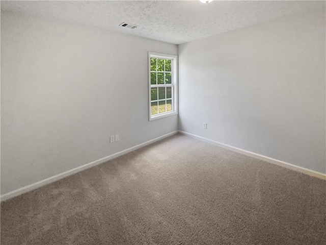 30 Trelawney Ct, Covington, GA 30016 - spare room with carpet floors, a textured ceiling, baseboards, and visible vents