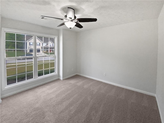 30 Trelawney Ct, Covington, GA 30016 - carpeted empty room with baseboards, a ceiling fan, a textured ceiling, and visible vents