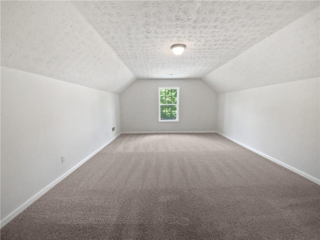 30 Trelawney Ct, Covington, GA 30016 - bonus room with carpet flooring, a textured ceiling, baseboards, and lofted ceiling