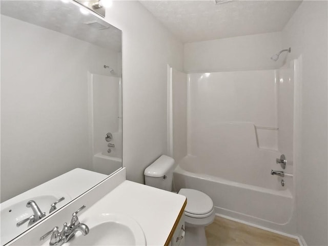 30 Trelawney Ct, Covington, GA 30016 - full bathroom featuring toilet, a textured ceiling, bathing tub / shower combination, and vanity