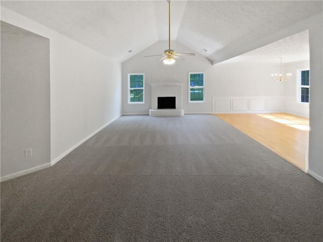 30 Trelawney Ct, Covington, GA 30016 - unfurnished living room with carpet floors, a fireplace with raised hearth, ceiling fan with notable chandelier, baseboards, and vaulted ceiling