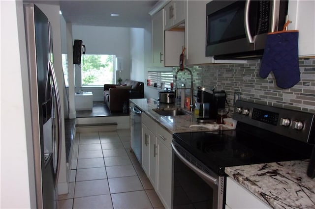 2814 Shellbark Rd, Decatur, GA 30035 - kitchen with stainless steel appliances, a sink, decorative backsplash, and light stone countertops