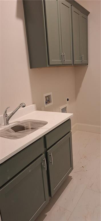 laundry room with cabinets, sink, hookup for an electric dryer, and hookup for a washing machine