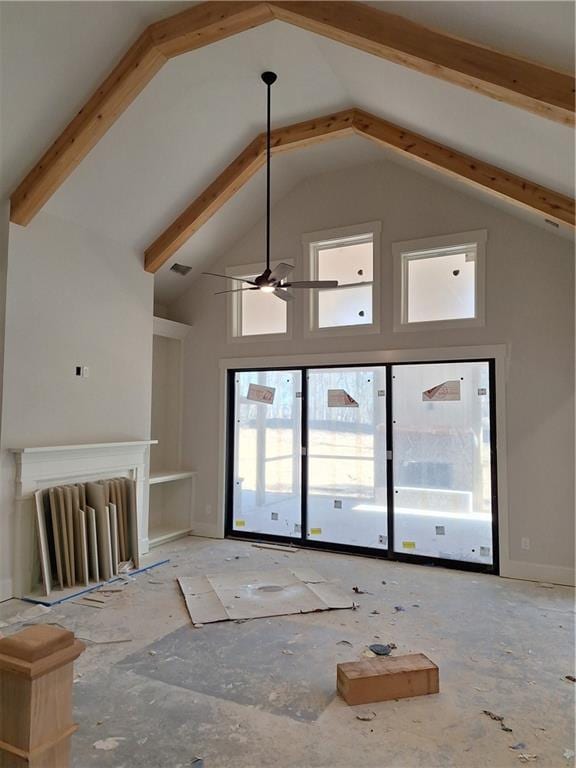 unfurnished living room with ceiling fan and high vaulted ceiling