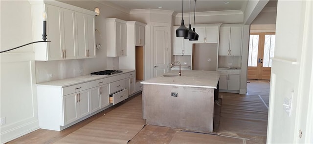 kitchen with white cabinetry, light stone countertops, a kitchen island with sink, and pendant lighting