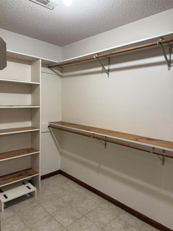 spacious closet featuring visible vents