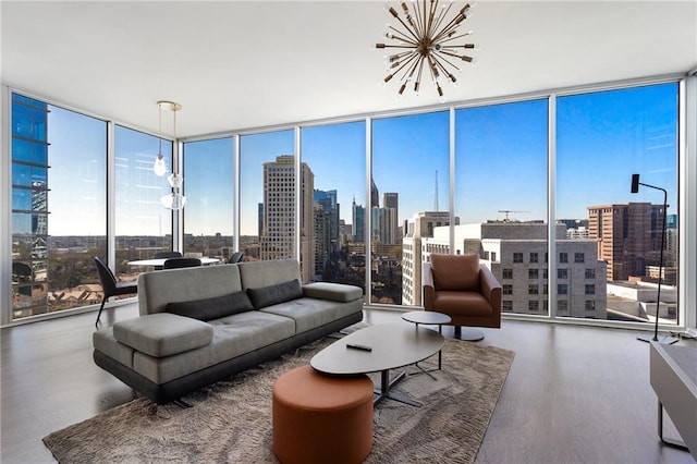 living area with a city view, floor to ceiling windows, a notable chandelier, and wood finished floors