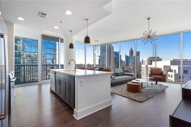 kitchen featuring visible vents, floor to ceiling windows, dark wood-style flooring, and a sink