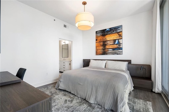 bedroom with visible vents, baseboards, and wood finished floors