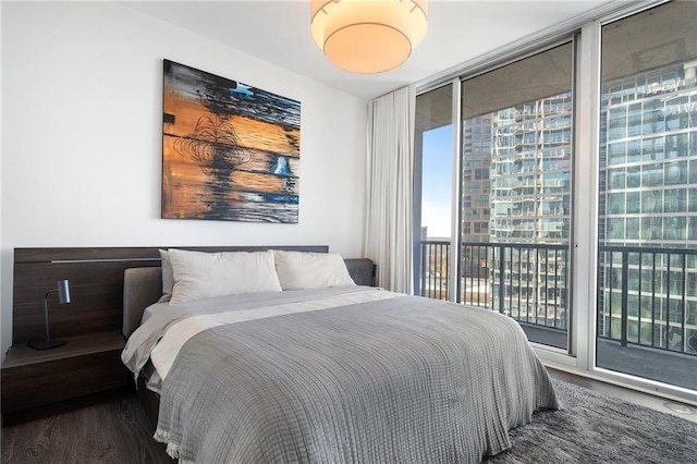 bedroom featuring wood finished floors and access to exterior