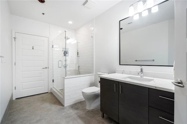 full bathroom with vanity, a shower stall, toilet, and visible vents