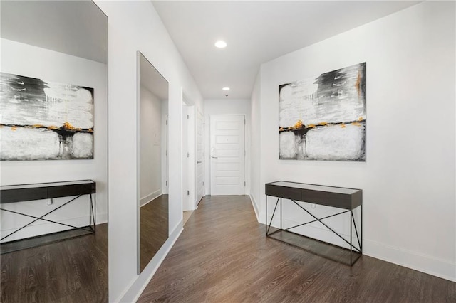hallway featuring recessed lighting, baseboards, and wood finished floors